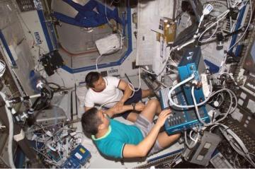U.S. Commander Leroy Chiao performed an ultrasound bone scan on the elbow of Kyrgyzstani Flight Engineer Salizhan Sharipov aboard the International Space Station in 2005. The drill was designed to prepare spacefarers for injuries and illnesses, as well as for ongoing medical research. (NASA photo)